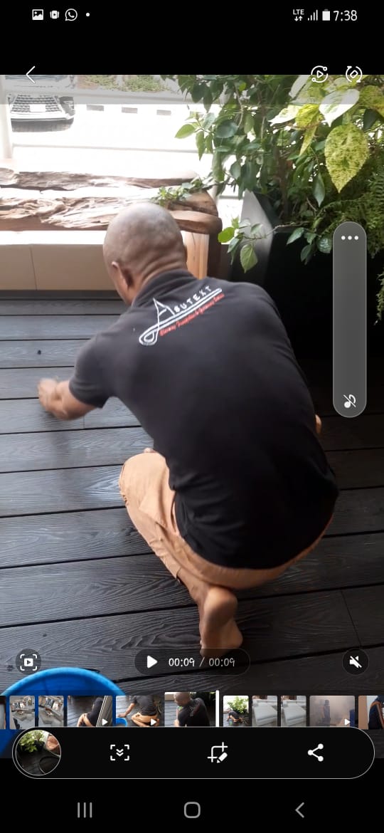 Asutext team refurbishing and cleaning outdoor wooden deck
