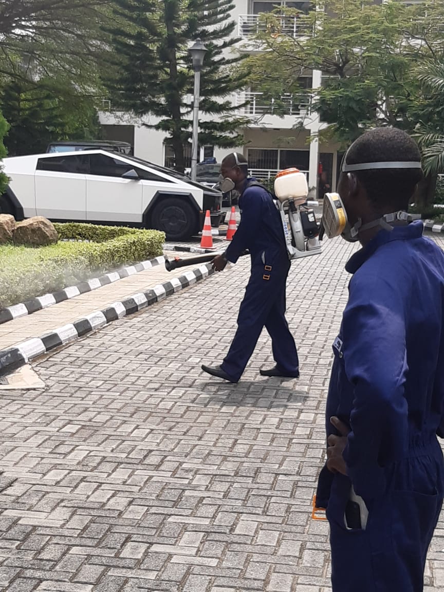 Fumigator disinfecting commercial building exterior