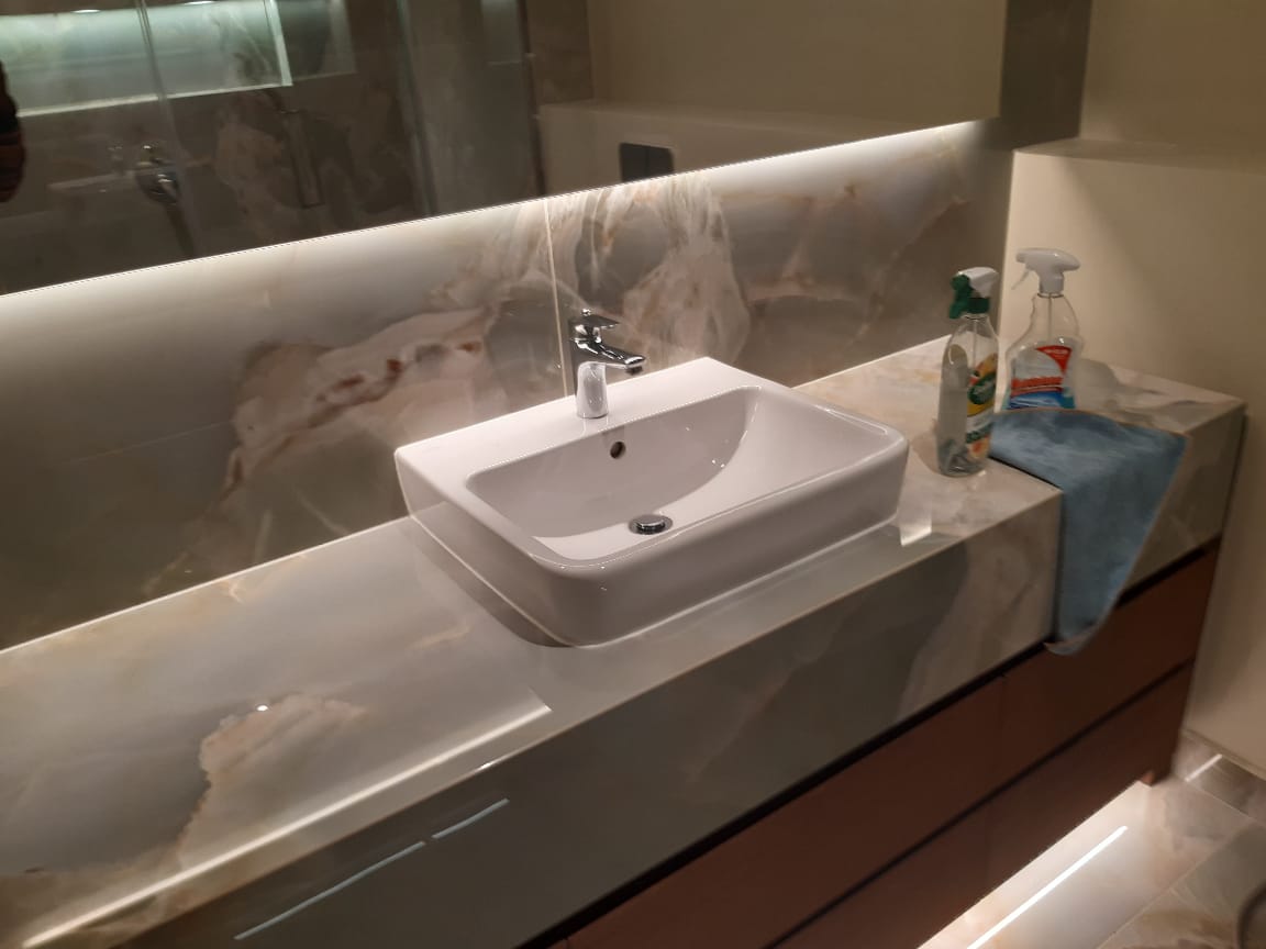 Spotless clean bathroom sink faucet and counter