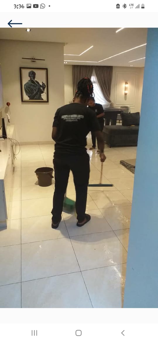 Janitorial staff mopping tiled office floor