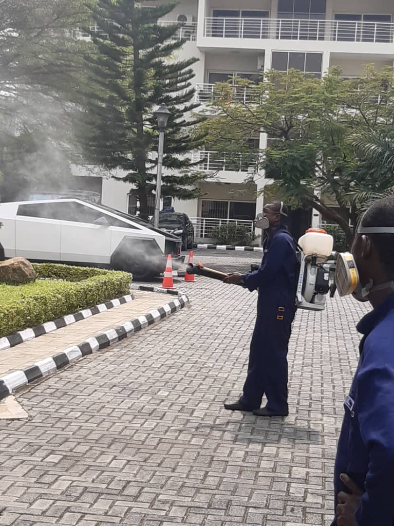 Fumigation staff spraying outdoor garden area